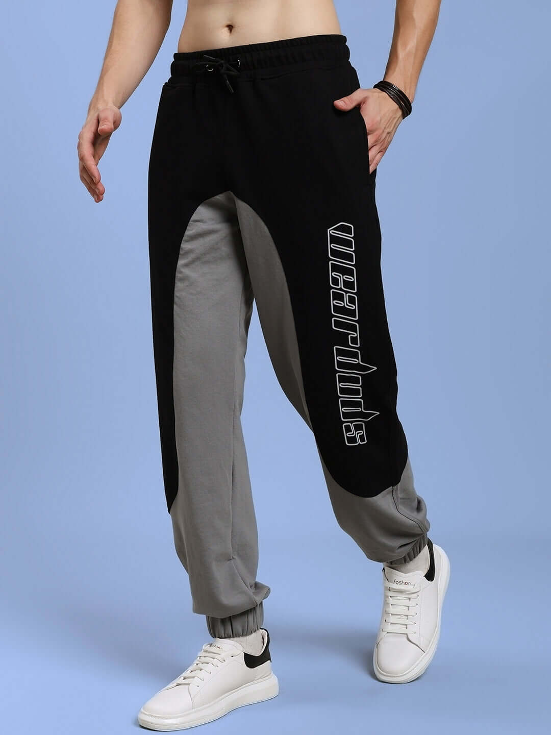 BERLIN Relaxed Fit Joggers in black and grey, featuring customizable fit options, designed by DUDS, shown on a model wearing white sneakers.