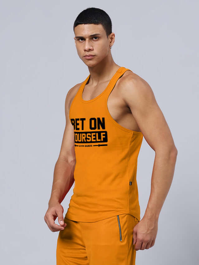 Orange 'Bet On Yourself' gym tank top for men, promoting custom fit options and handmade quality by DUDS.