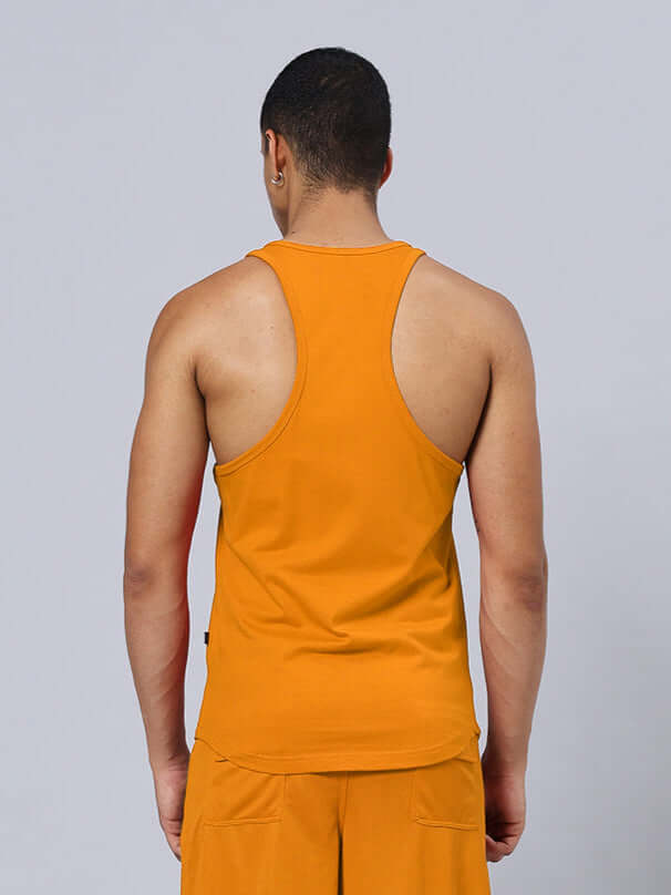 Back view of a man wearing an orange gym t-shirt, showcasing the 'Bet On Yourself' print, available for custom fit orders.