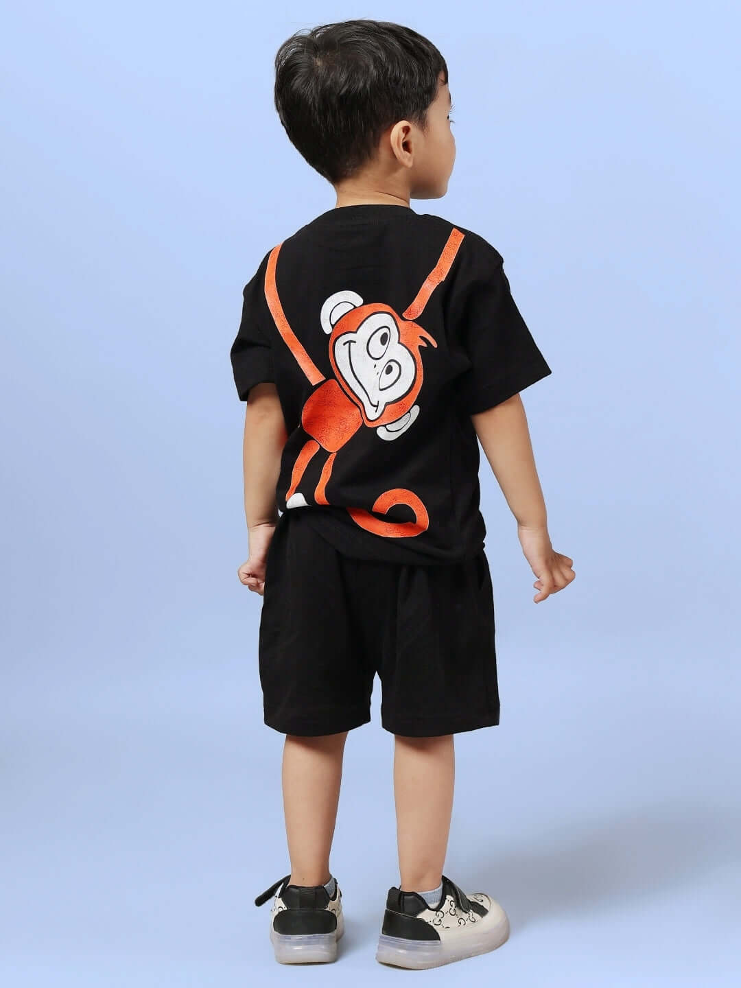 Child wearing BINGO CO-ORD FOR BOYS & GIRLS BLACK with playful design on the back, perfect for made-to-order kids fashion.