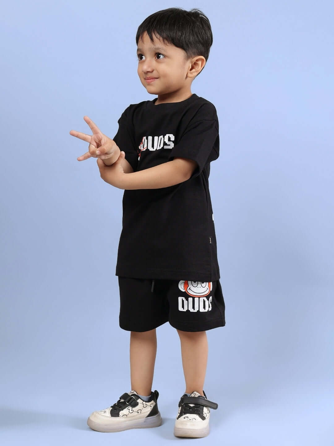 Child wearing BINGO CO-ORD FOR BOYS & GIRLS BLACK outfit by DUDS, featuring a comfortable t-shirt and shorts. Available for custom fit.