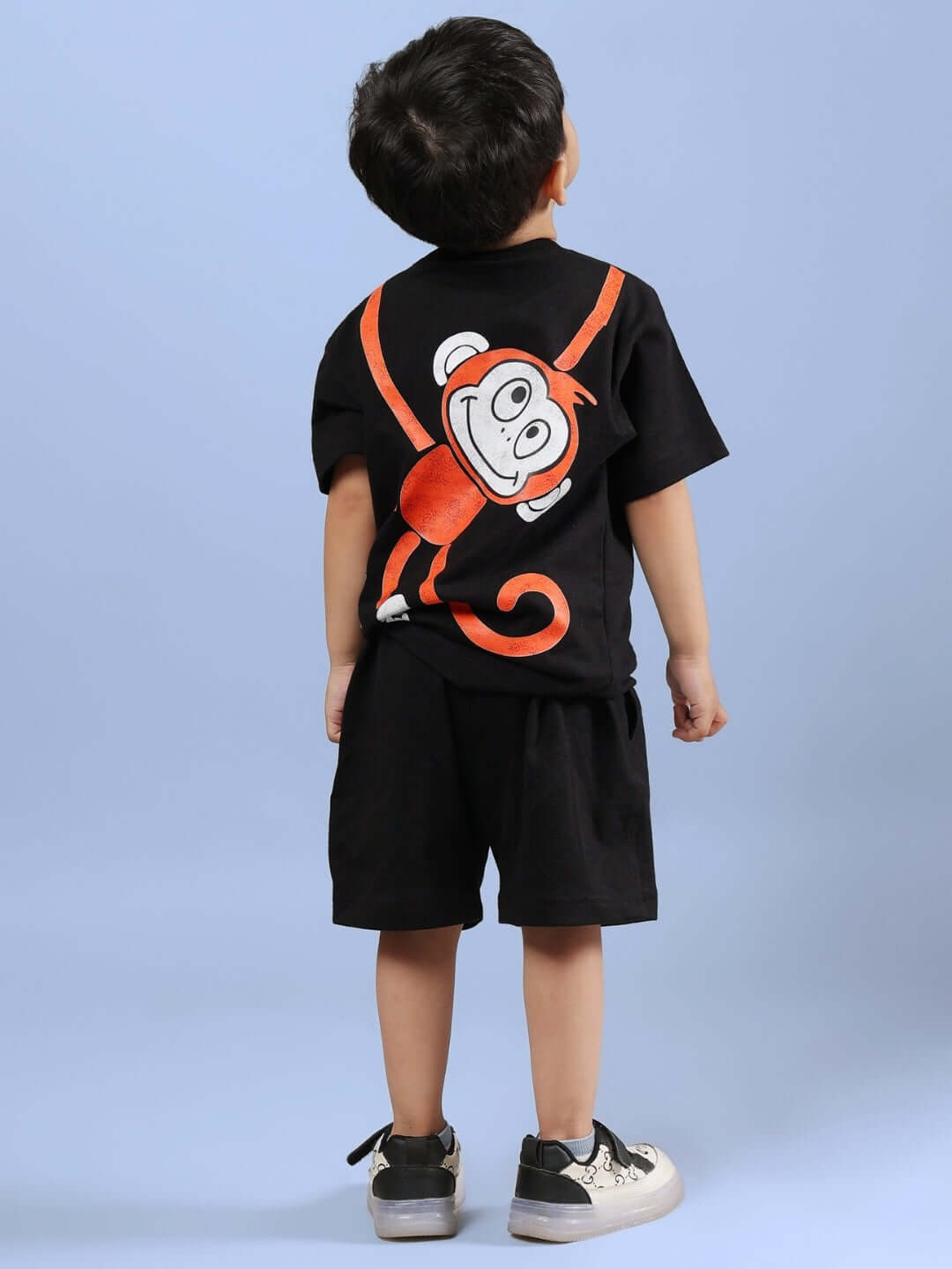 Child wearing black Bingo Co-ord set with playful monkey design from DUDS, suitable for boys and girls, customizable sizing available.