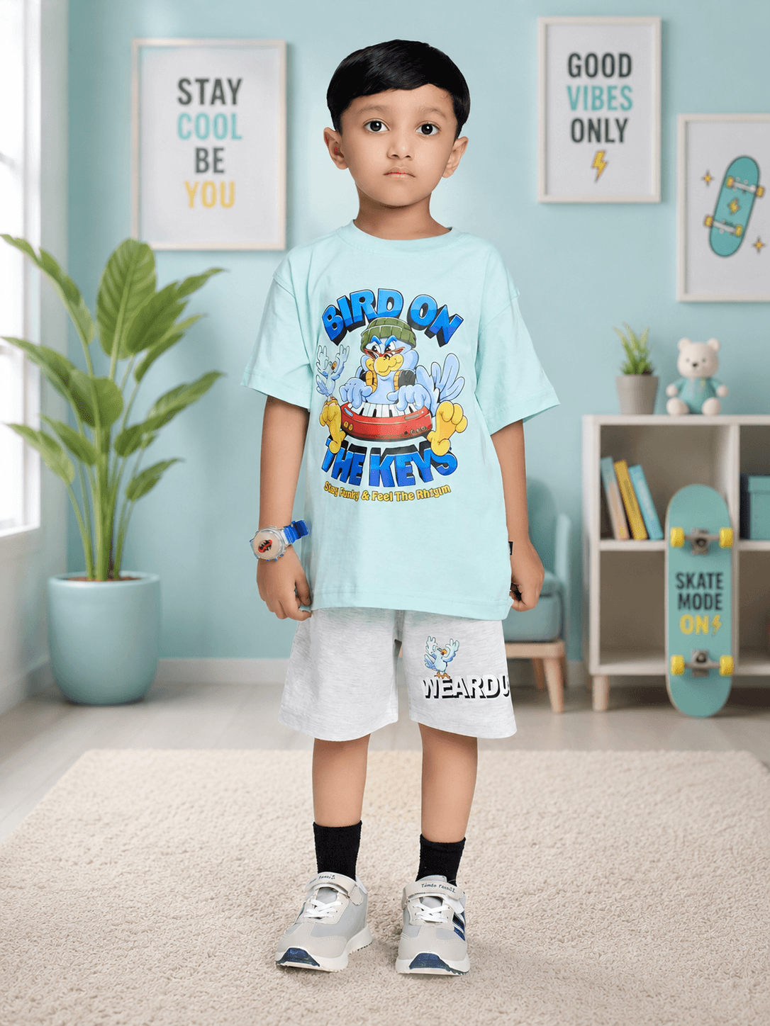 BIRD ON THE KEYS CO-ORD FOR BOYS GIRLS SKY BLUE LIGHT GRAY worn by a boy in a stylish room setting.