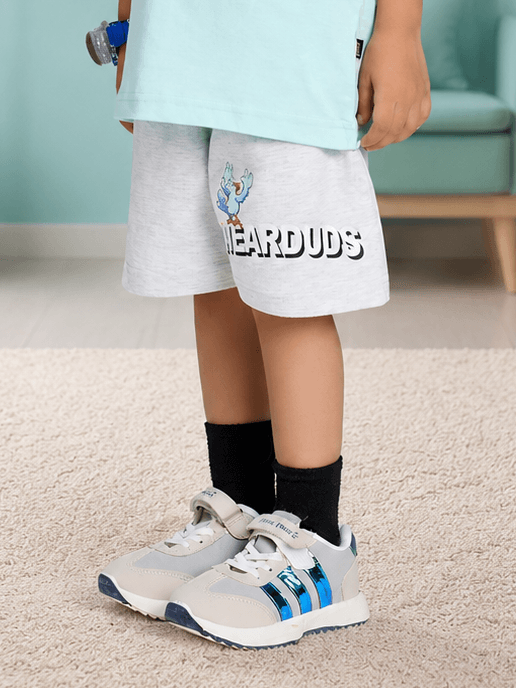 BIRD ON THE KEYS COOL SHORTS FOR BOYS GIRLS LIGHT GRAY worn by a child, paired with stylish sneakers.