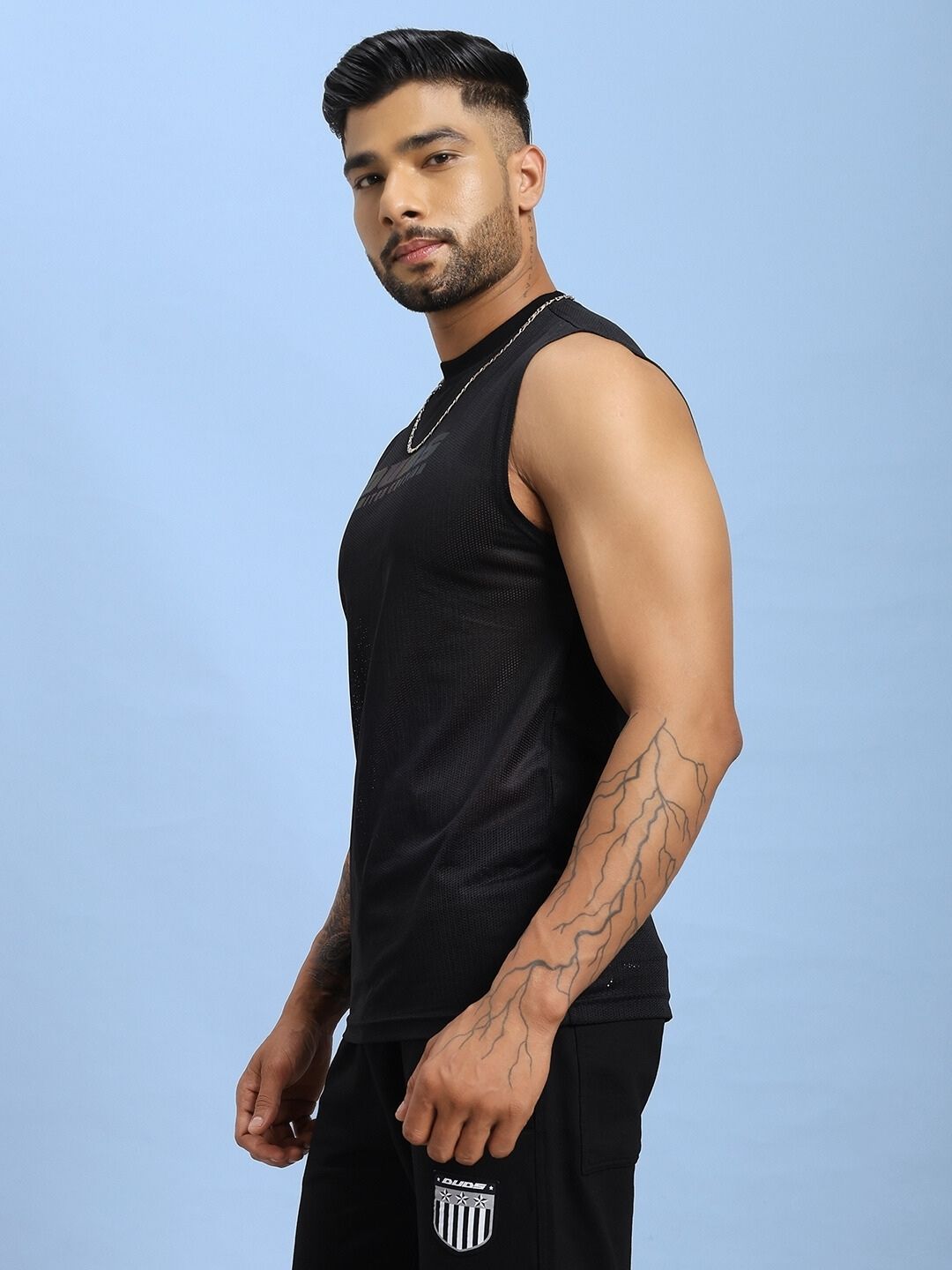 Man wearing AIR-FLOW REGULAR FIT T-SHIRT BLACK showcasing comfort and style with advanced Air-Flow fabric technology.