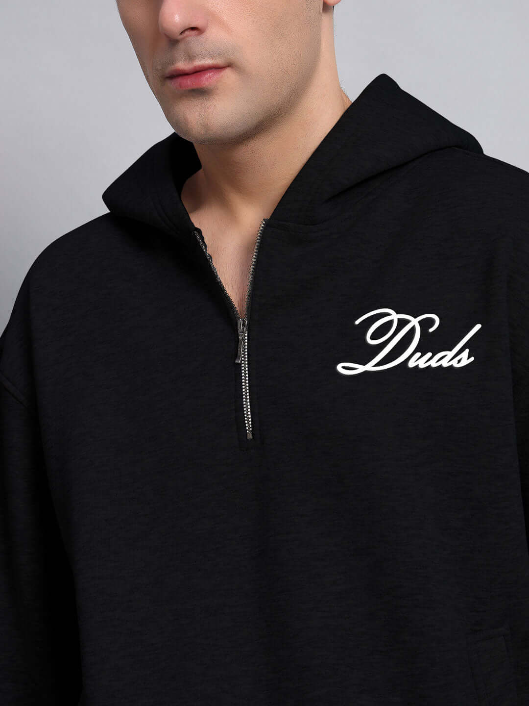 Person wearing WEARDUDS AMARILLO FLEECE HOODIE BLACK with Duds logo embroidered, showcasing stylish and comfortable fashion.