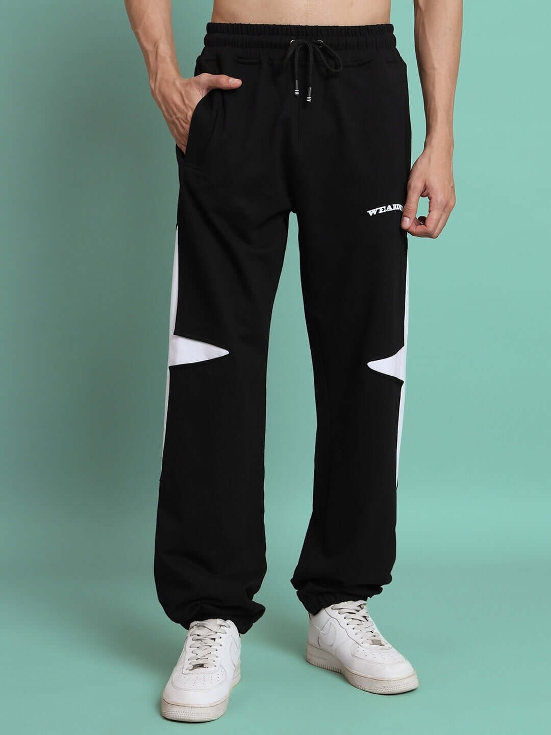 Black jogger pants with white crossed star design, made to order by DUDS, suitable for custom fit options.