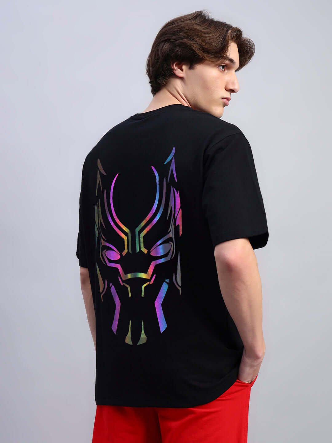 Model wearing Black Panther reflector oversized black t-shirt, featuring colorful design, made from premium cotton blend. Made in India.