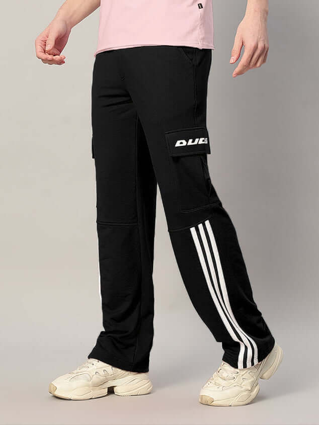 Man wearing black REDROIT 5 Pocket Relaxed Fit Joggers with side stripes, paired with white sneakers.