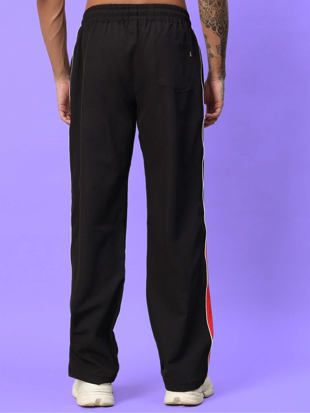 Back view of black string parachute cargo pants with adjustable drawstring and bold streetwear style.