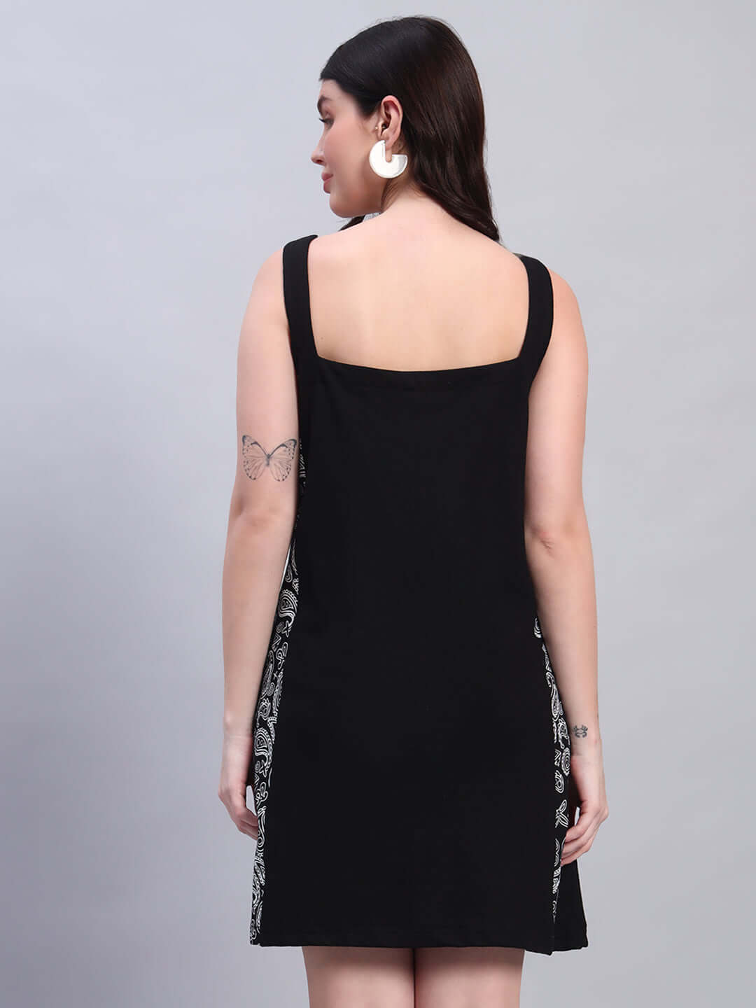 Black women's KUDOS dress featuring four-way Lycra and side patterns, made from 90% polyester & 10% spandex, worn by a model.