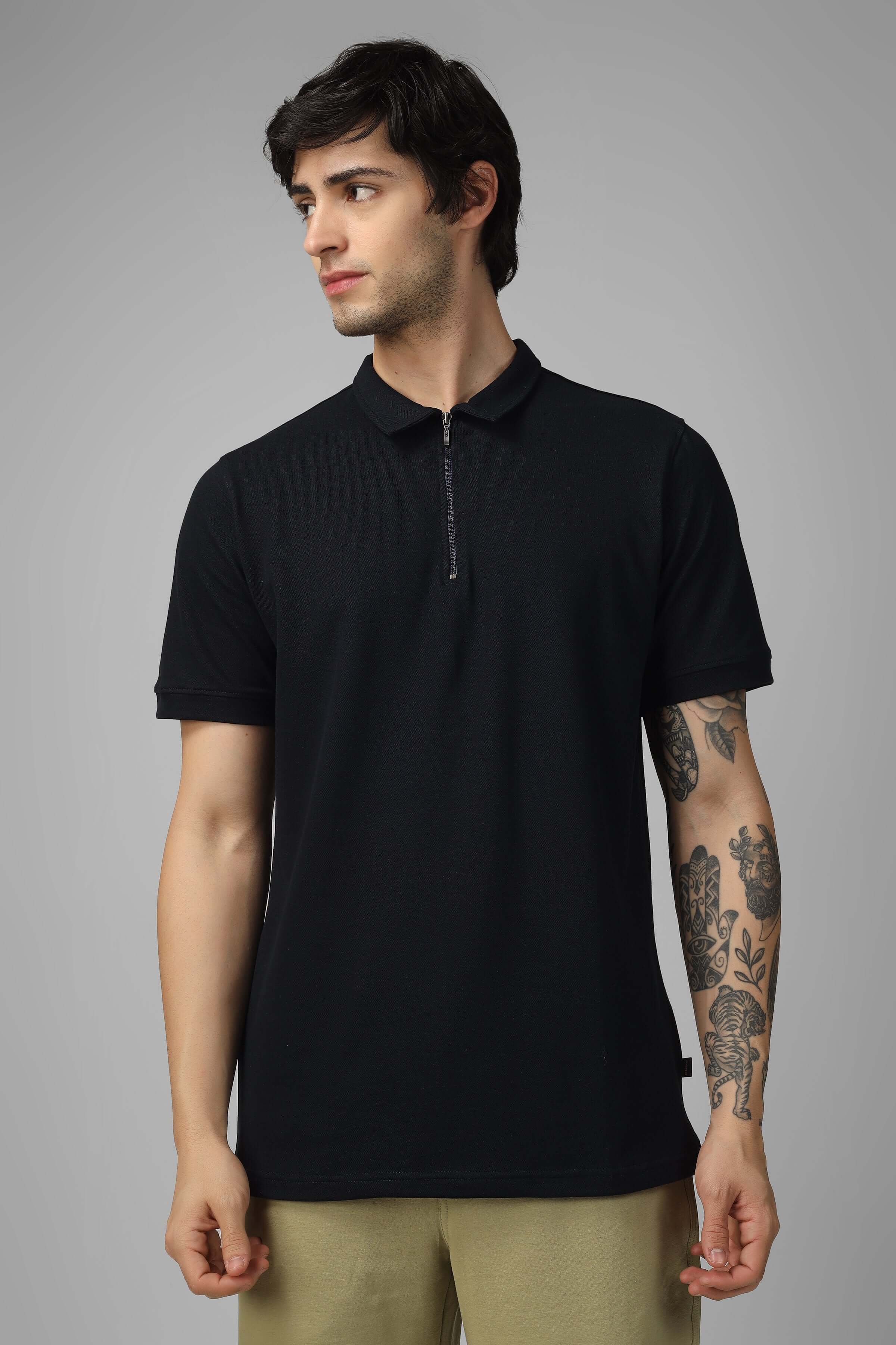 Man wearing black zipper polo neck t-shirt made of Sporty Pique Cotton Lycra, showcasing sleek style and comfort.