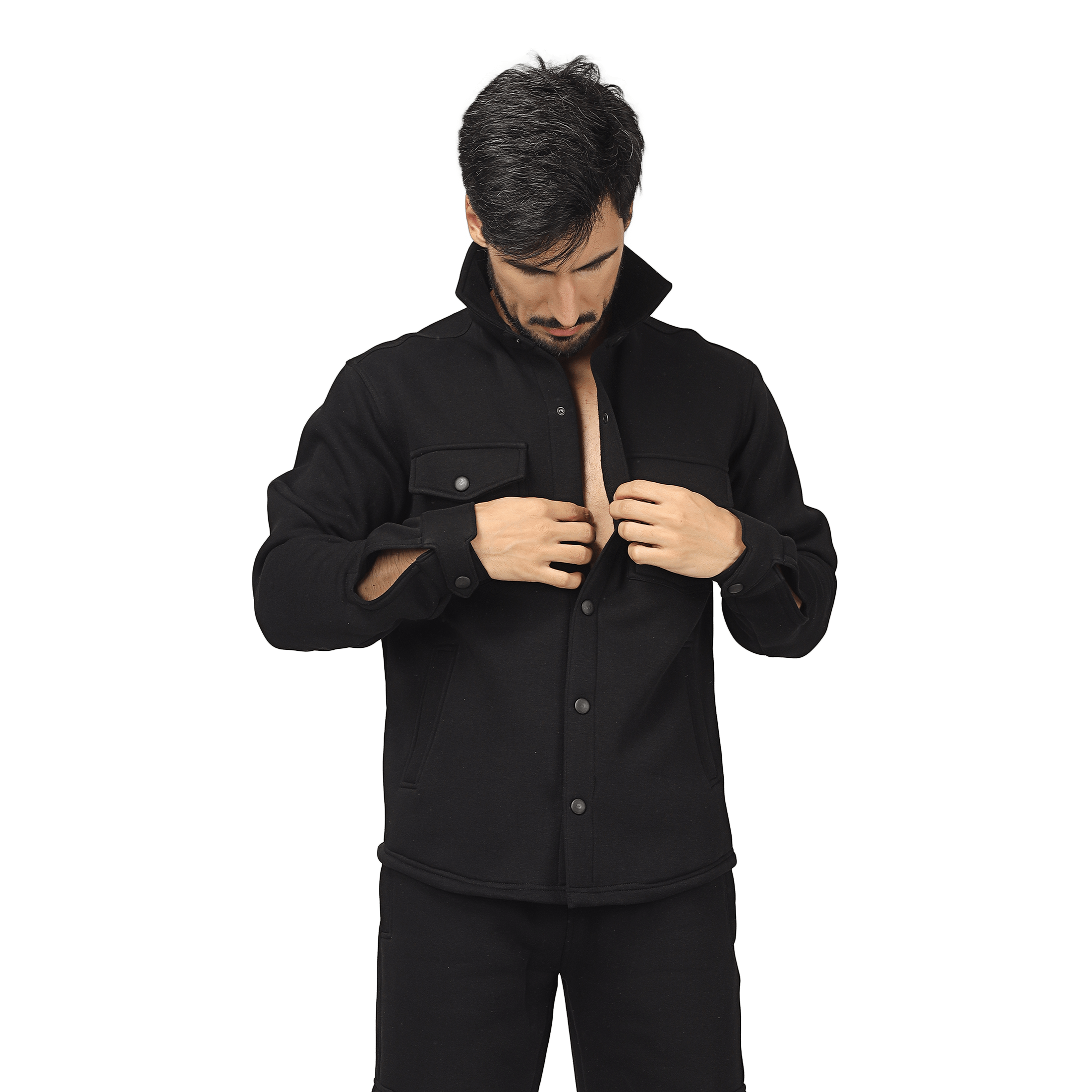 Man wearing a black relaxed fit full-overshirt, buttoning the front, showcasing a streetwear style.