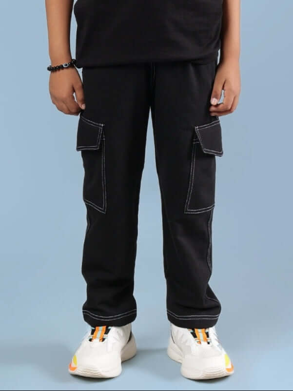 Child wearing black carpenter jogger pants with side pockets, designed for both boys and girls, suitable for casual wear.