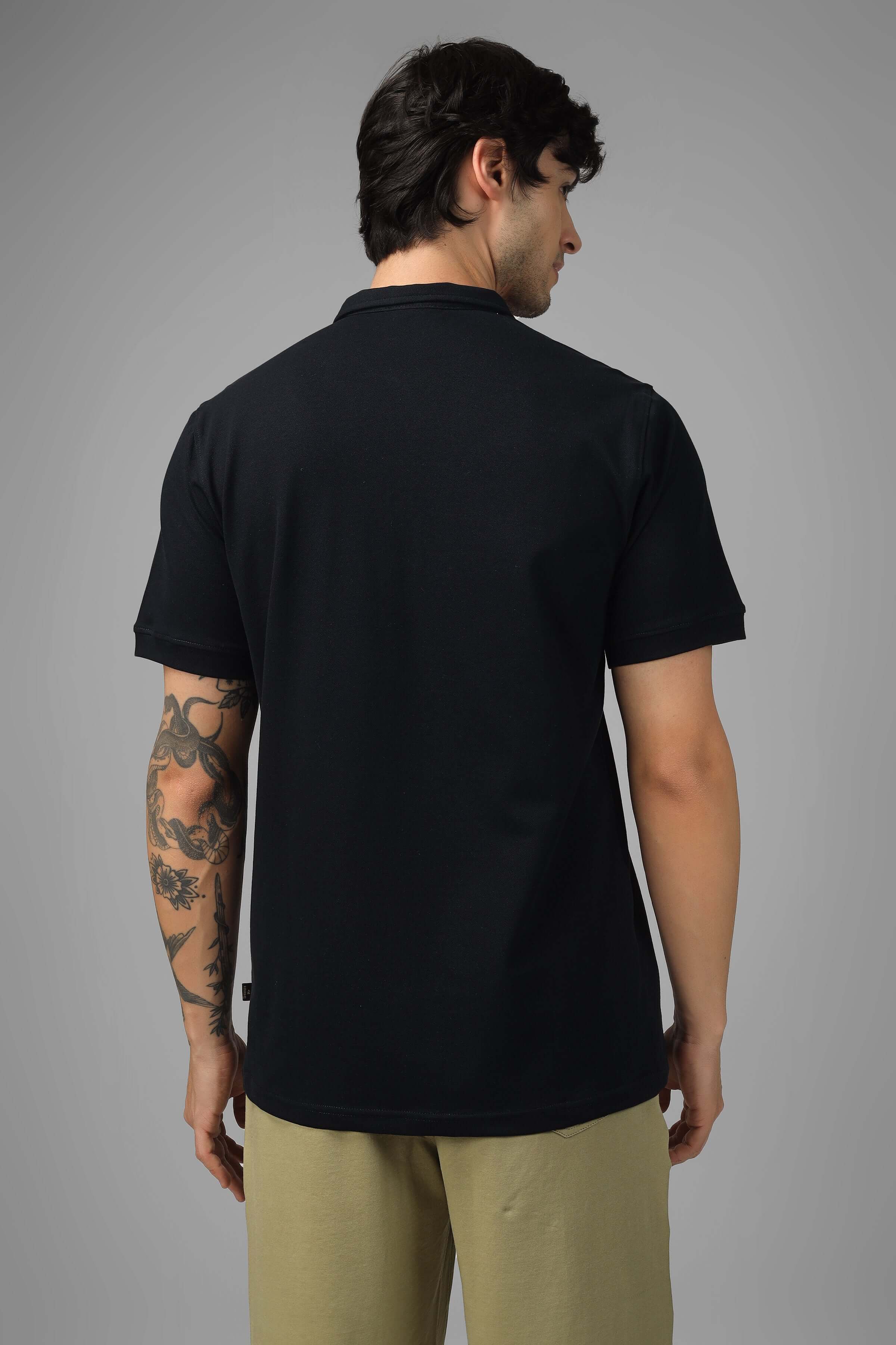 Back view of a black Zipper Polo Neck T-Shirt with short sleeves, made from Sporty Pique Cotton Lycra, worn by a model.