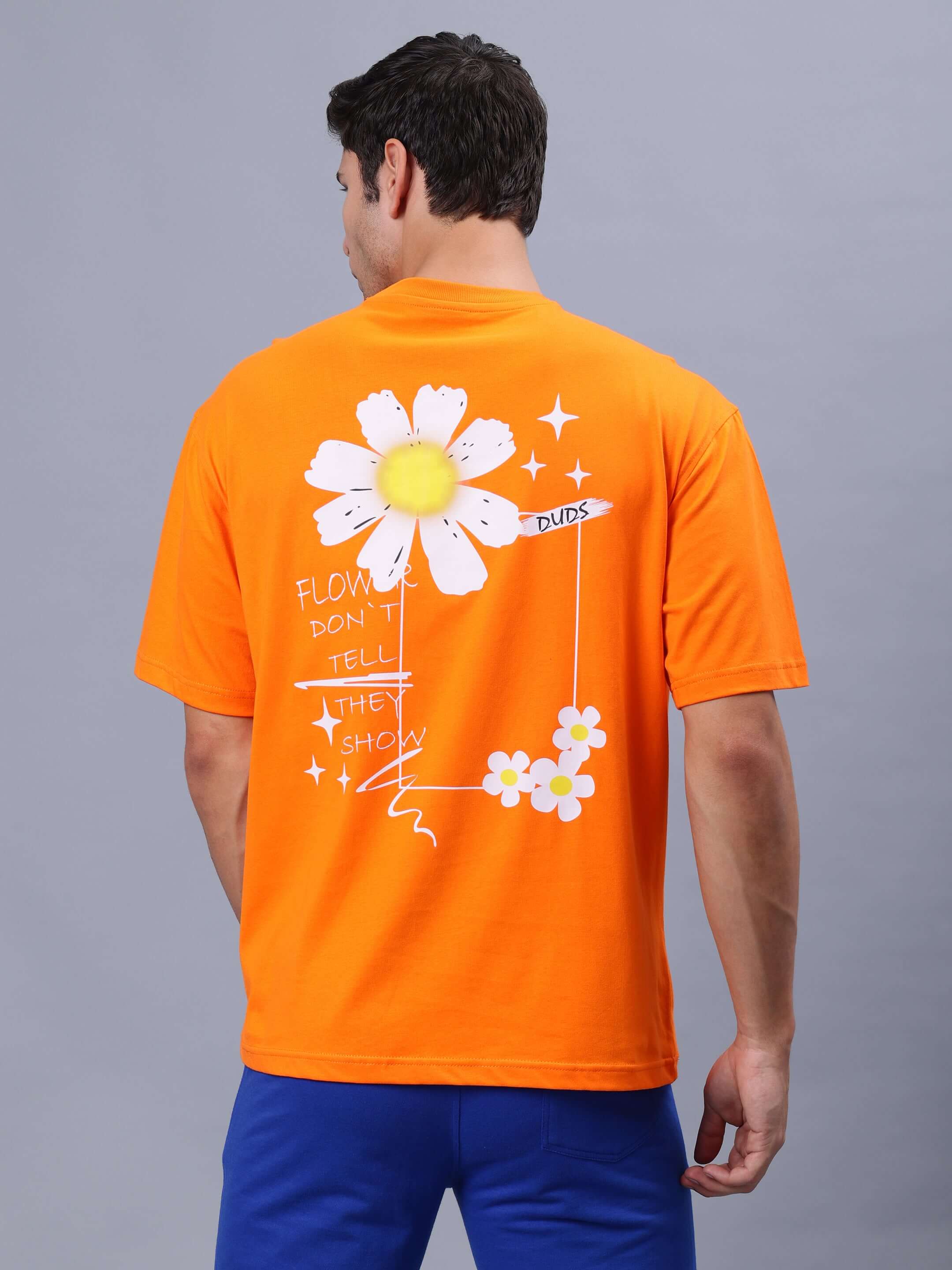 Back view of BLOOM QUOTE OVER-SIZED T-SHIRT in orange featuring a floral graphic and playful quote.