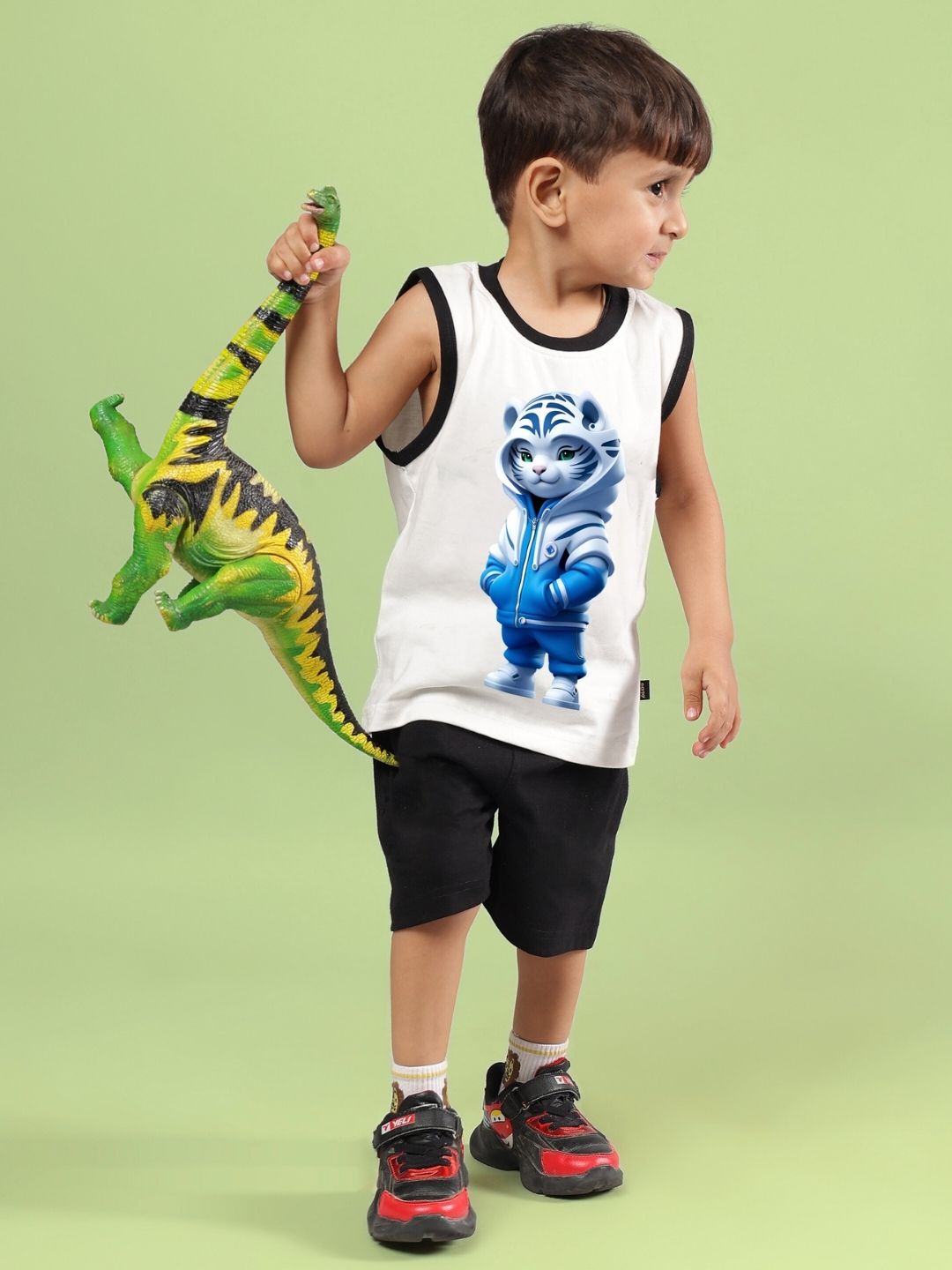Boy wearing blue cat summer co-ord in off white and black, holding a green dinosaur toy, perfect for boys and girls.