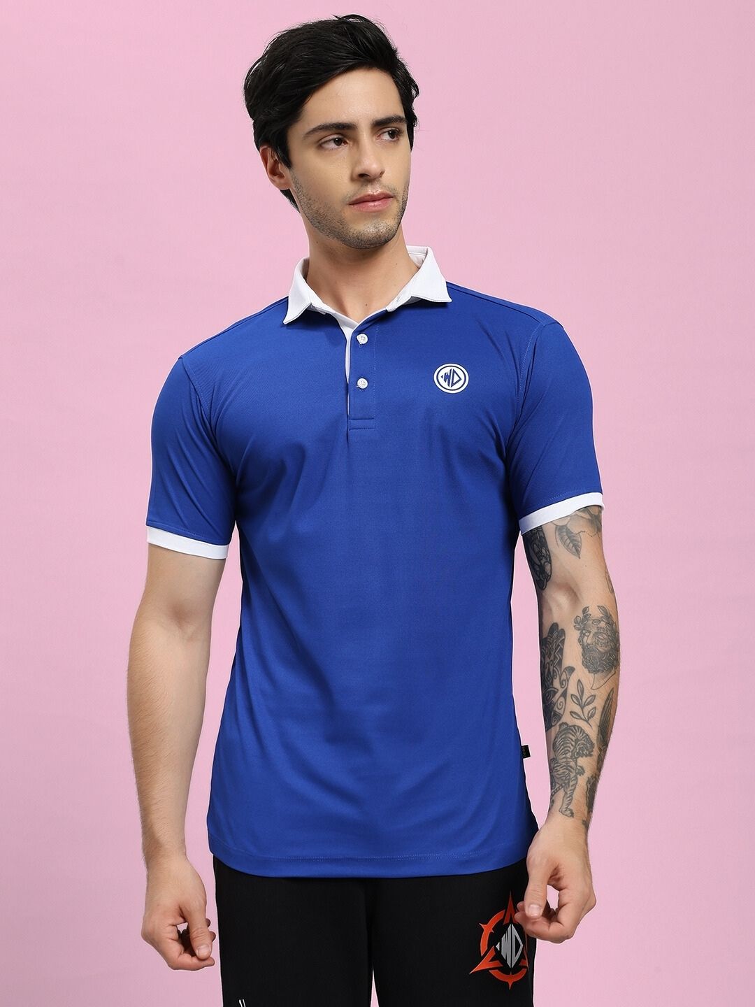 Man wearing EDGE POLO REGULAR FIT T-SHIRT BLUE with white trim and short sleeves, perfect for style and comfort.