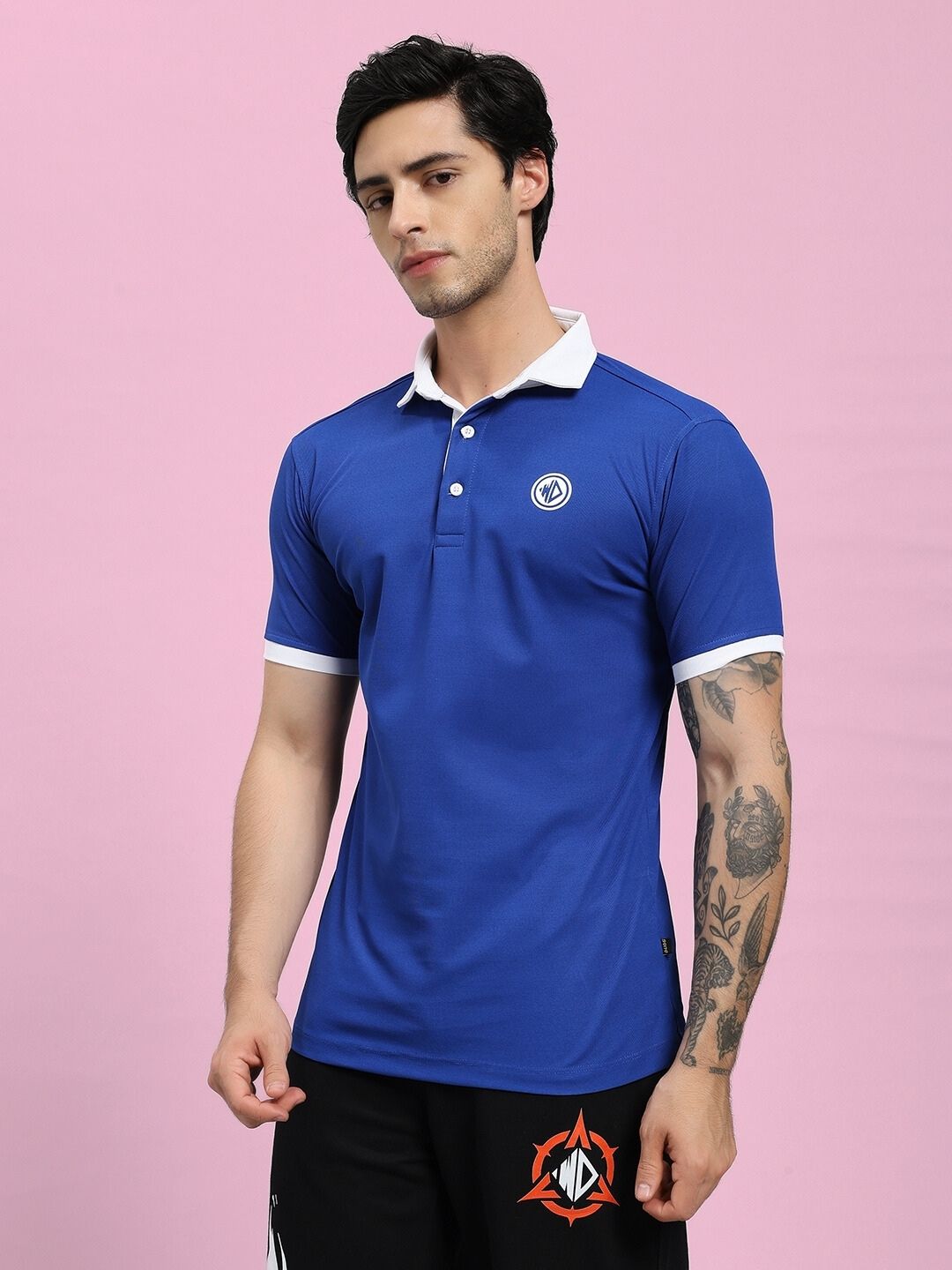 Man wearing EDGE POLO REGULAR FIT T-SHIRT BLUE, showcasing stylish and comfortable design for active lifestyles.