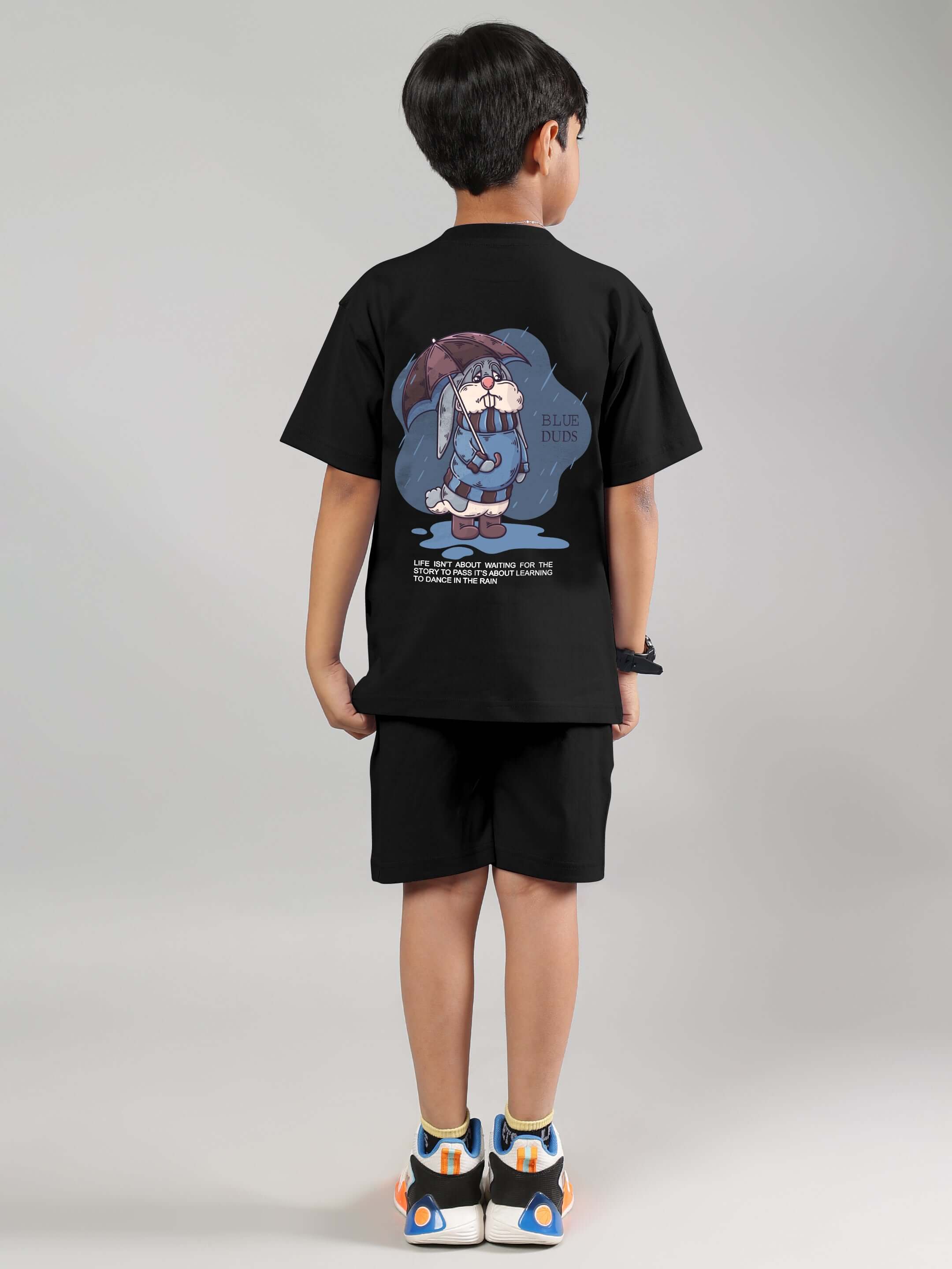 Boy wearing Blue Lapin black co-ord set with a playful graphic, perfect for kids' fashion. Made to order by DUDS tailors.