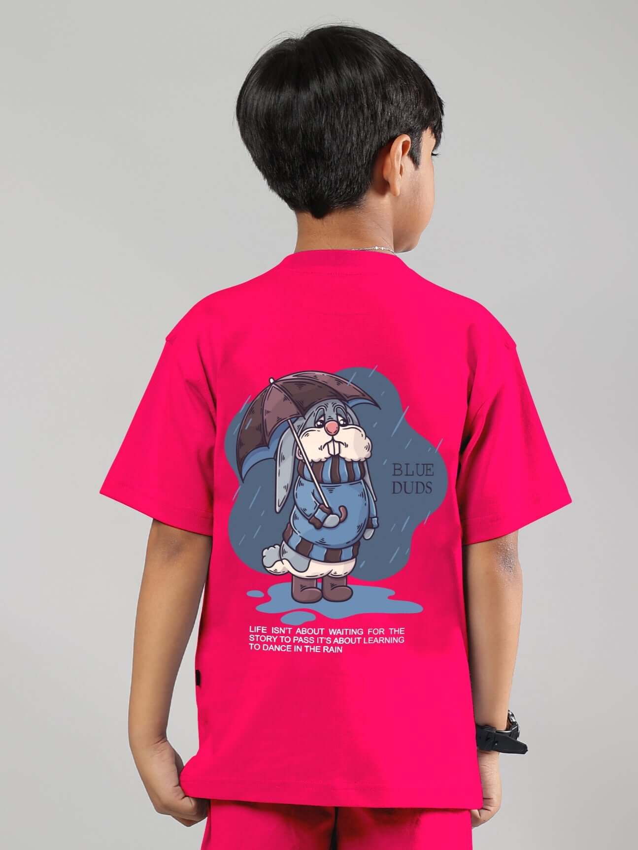 Child wearing pink Blue Lapin t-shirt with bunny graphic, showcasing playful design and comfort.