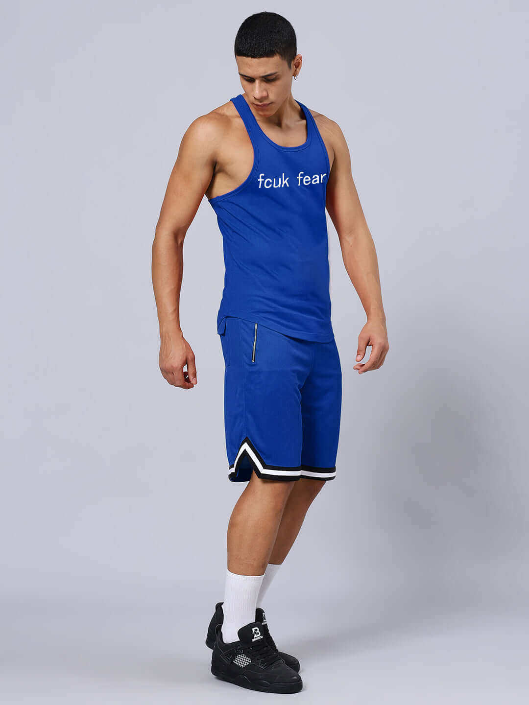 Blue "Fck Fear" printed gym co-ord set featuring tank top and shorts made from cotton and polyester, suitable for workouts.