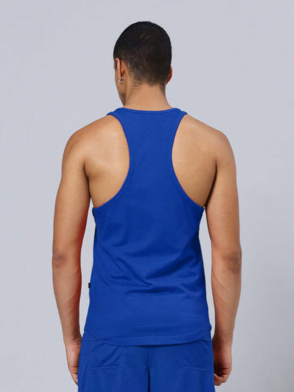 Back view of a person wearing a blue gym tank top, showcasing a sporty and comfortable design suitable for workouts.