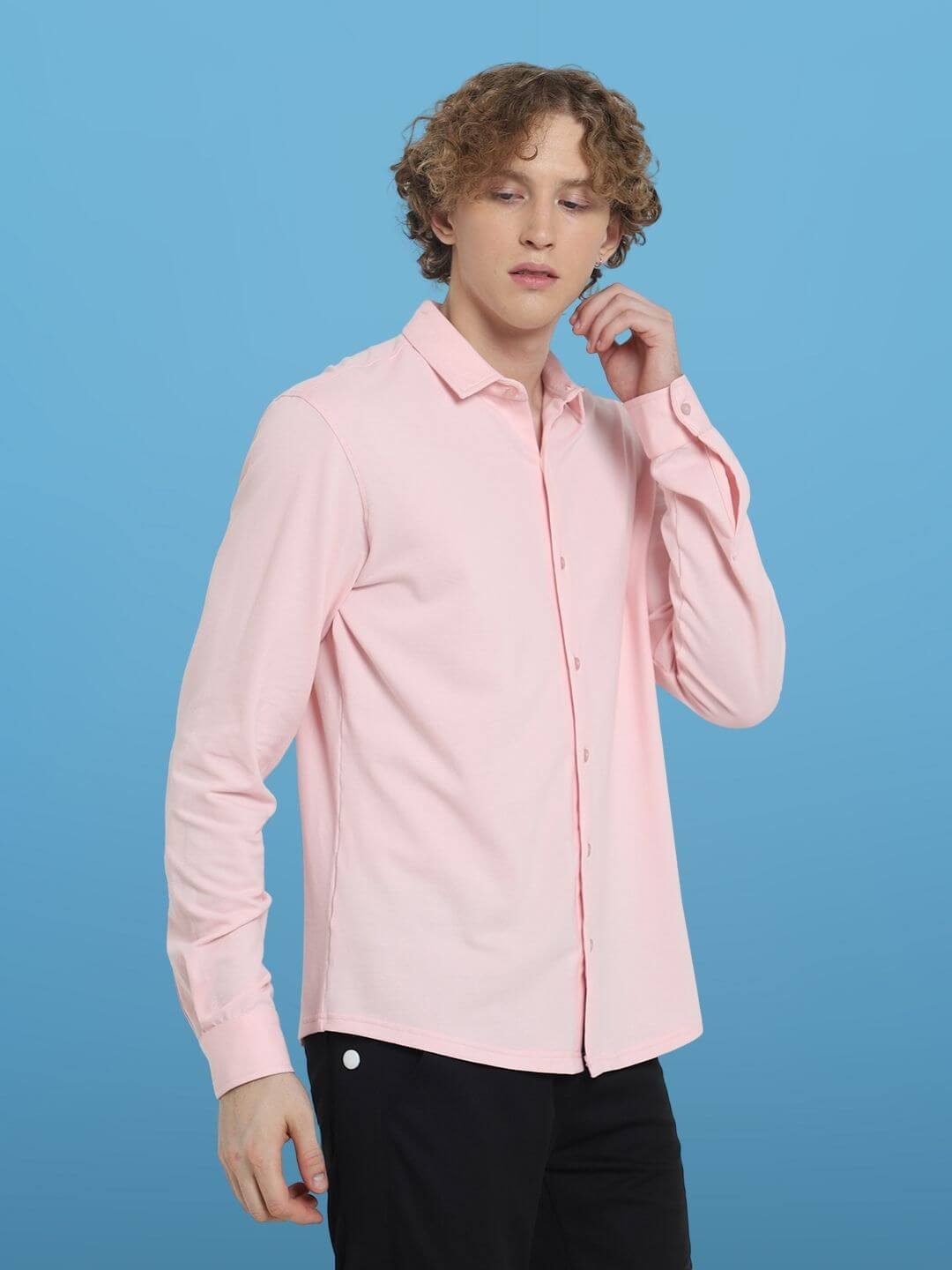 Blush pink sporty pique shirt with full sleeves worn by a male model, showcasing stretch, wrinkle-free cotton lycra fabric on a blue background.