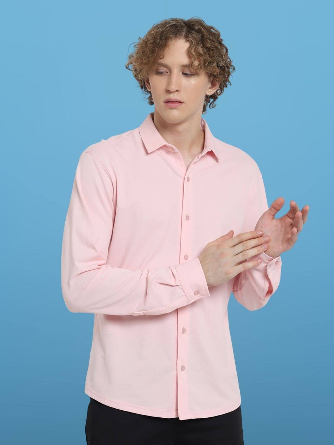 Model wearing blush pink sporty pique shirt, full sleeve, slim fit, 100% cotton lycra, wrinkle-free with lifetime no fade guarantee.