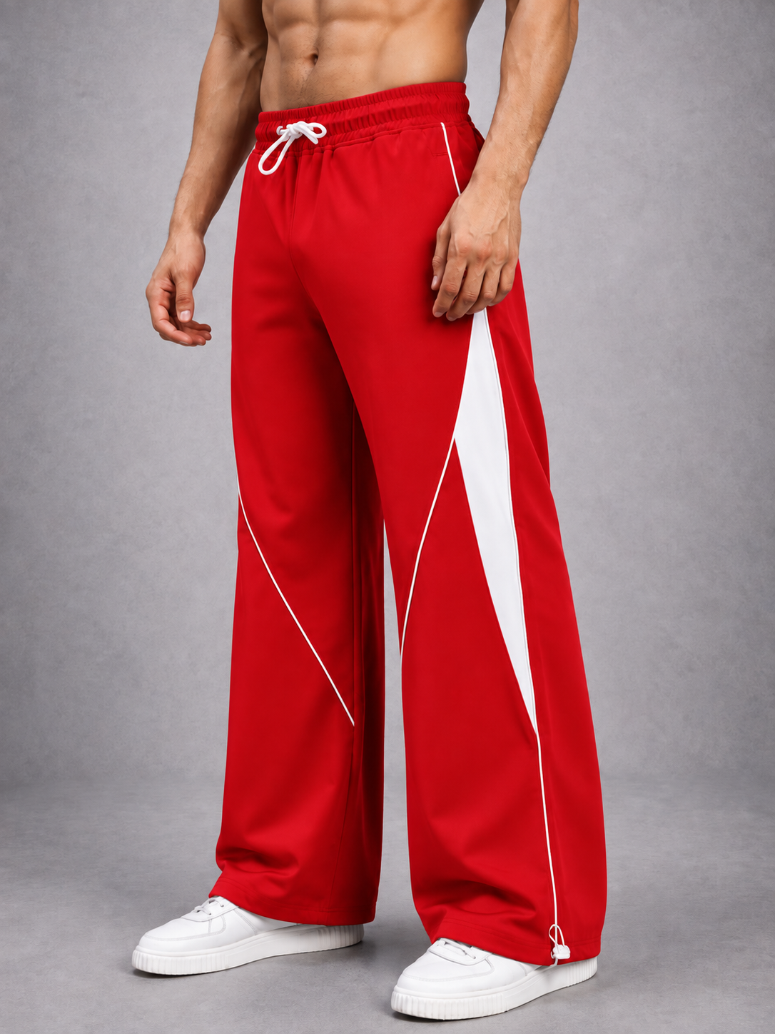 BOLD ELECTRIC RELAXED FIT JOGGERS RED WHITE styled with white sneakers, showcasing a relaxed streetwear silhouette for men