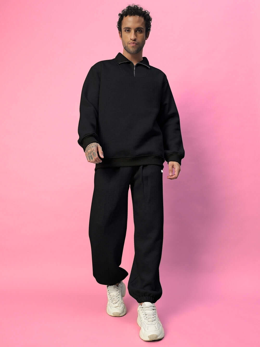 Model wearing BONA-FIDE Cotton Fleece Pant in black, showcasing premium comfort and style against a pink background.