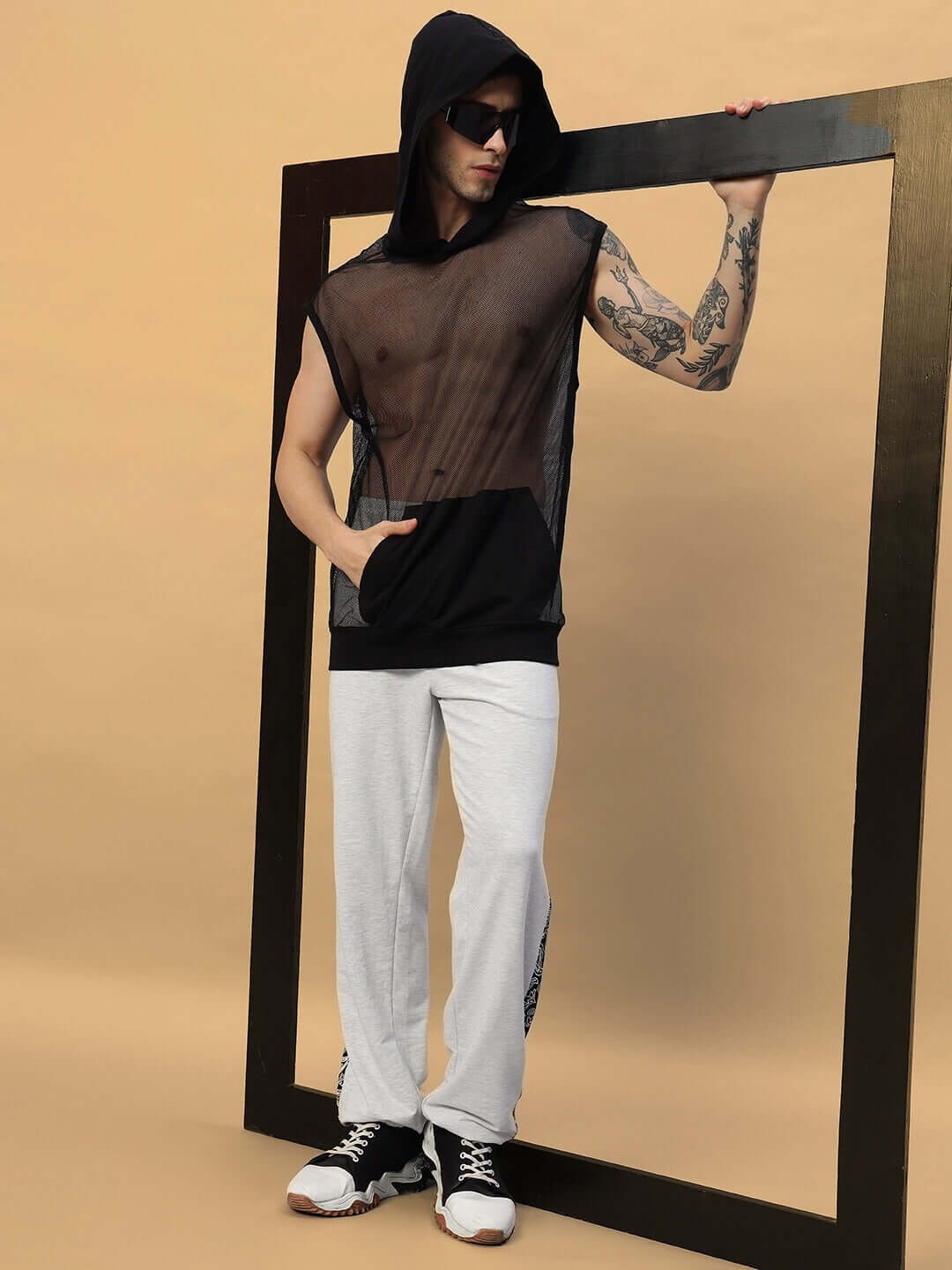 Model wearing Boogie Mesh Sleeveless Hoodie Vest in black, featuring a hooded design and casual fit.