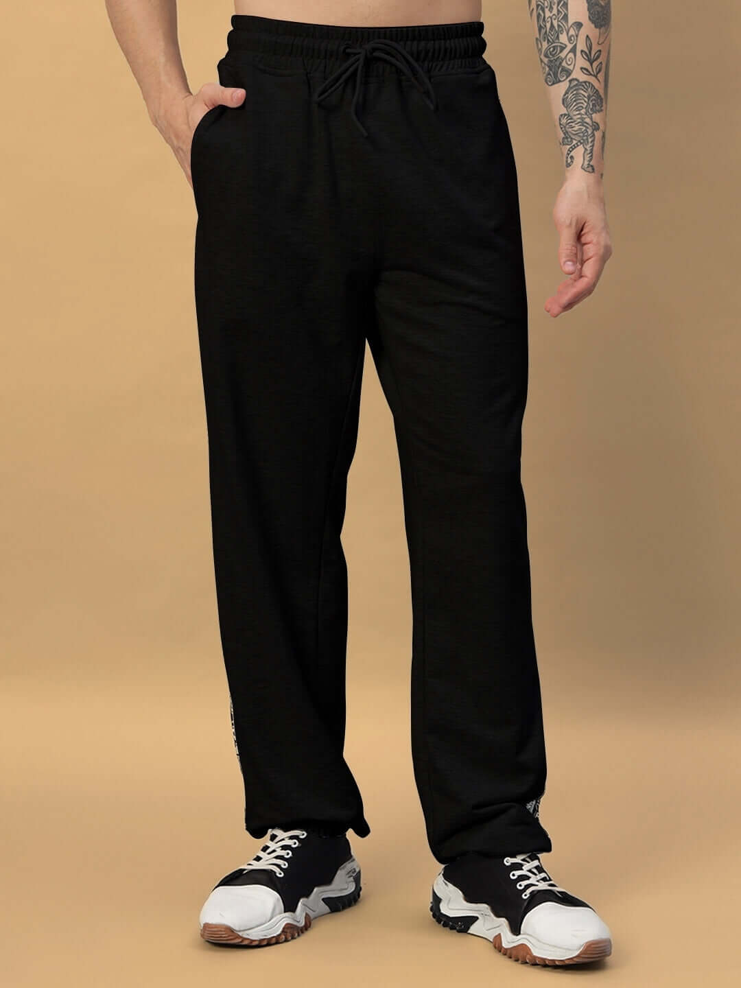 Person wearing BOOGIE Relaxed Fit Joggers in black, showcasing comfortable and stylish design. Available for custom fit.