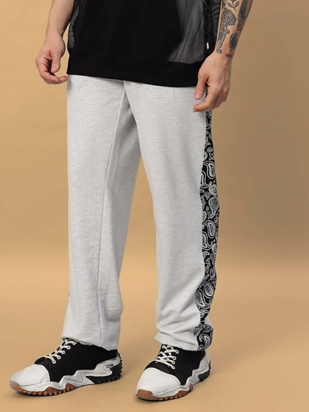 Model wearing Boogie Relaxed Fit Joggers in Melange Grey with patterned side, made to order by DUDS Tailors.