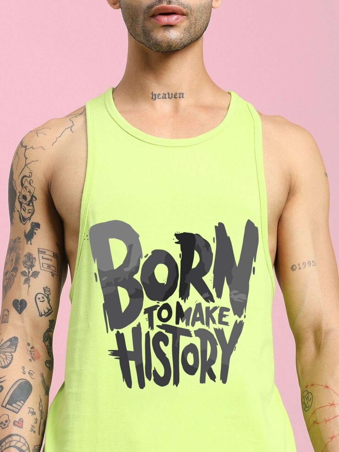 Person wearing BORN TO MAKE HISTORY GYM VEST T-SHIRT NEON GREEN with motivational text print, ideal for intense workouts.
