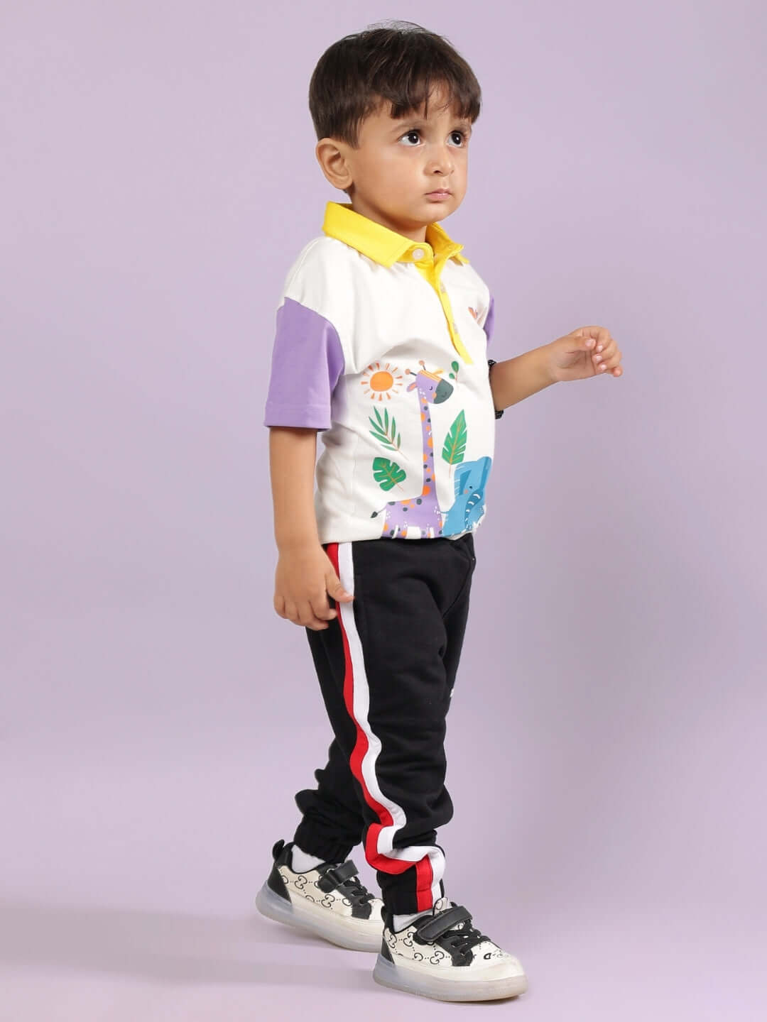 BORNEO CO-ORD FOR BOYS & GIRLS OFF WHITE-BLACK outfit with colorful shirt and black pants, worn by child against purple background