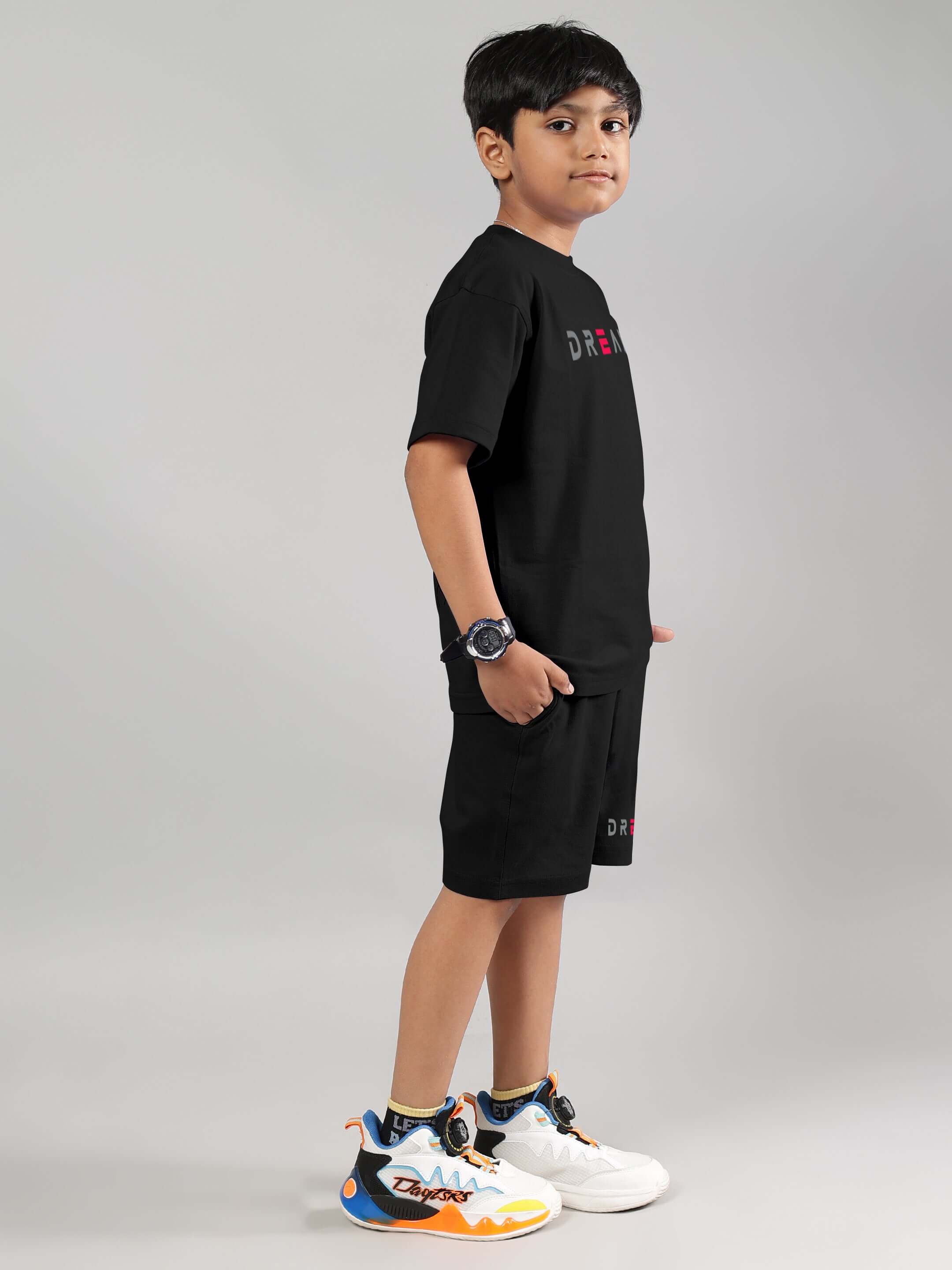 Child wearing black Fancy Dream Co-ord set, side view, by DUDS. Features comfortable made-to-order fit for boys and girls.
