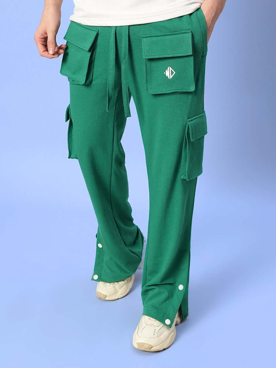Man wearing teal green BRACE 8 Pocket Cargo Pants, showcasing multiple pockets and relaxed fit with customizable options.