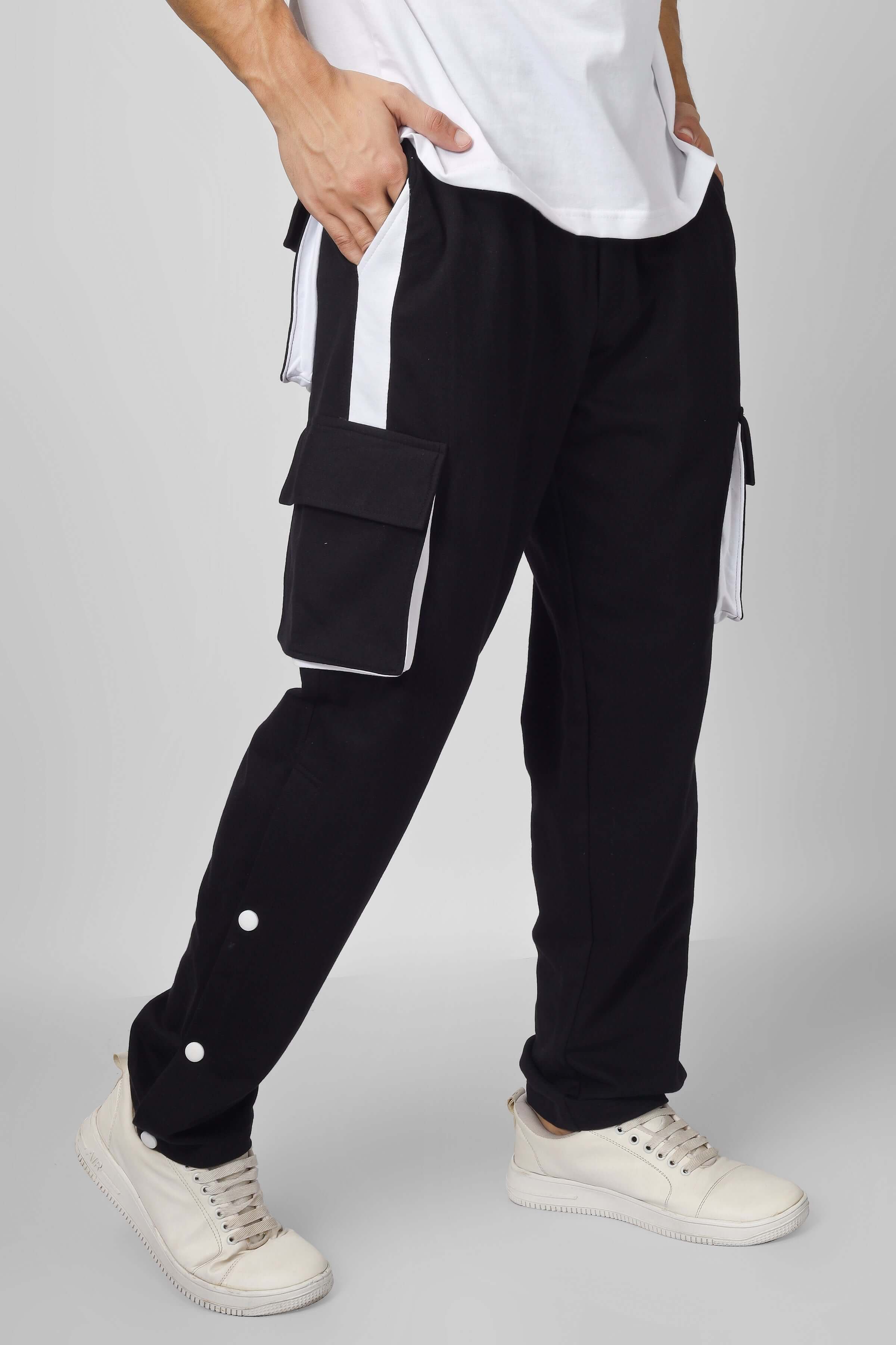 BRACKET Cargo Pant in black with white highlighter details, featuring multiple pockets and relaxed fit, worn by model.