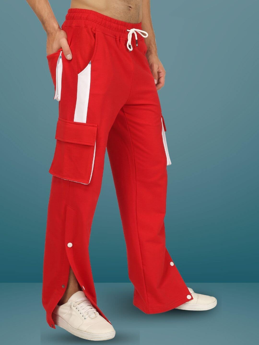 Red & white cargo pants with pockets and snap buttons, modeled against blue background, highlighting casual style and fit.