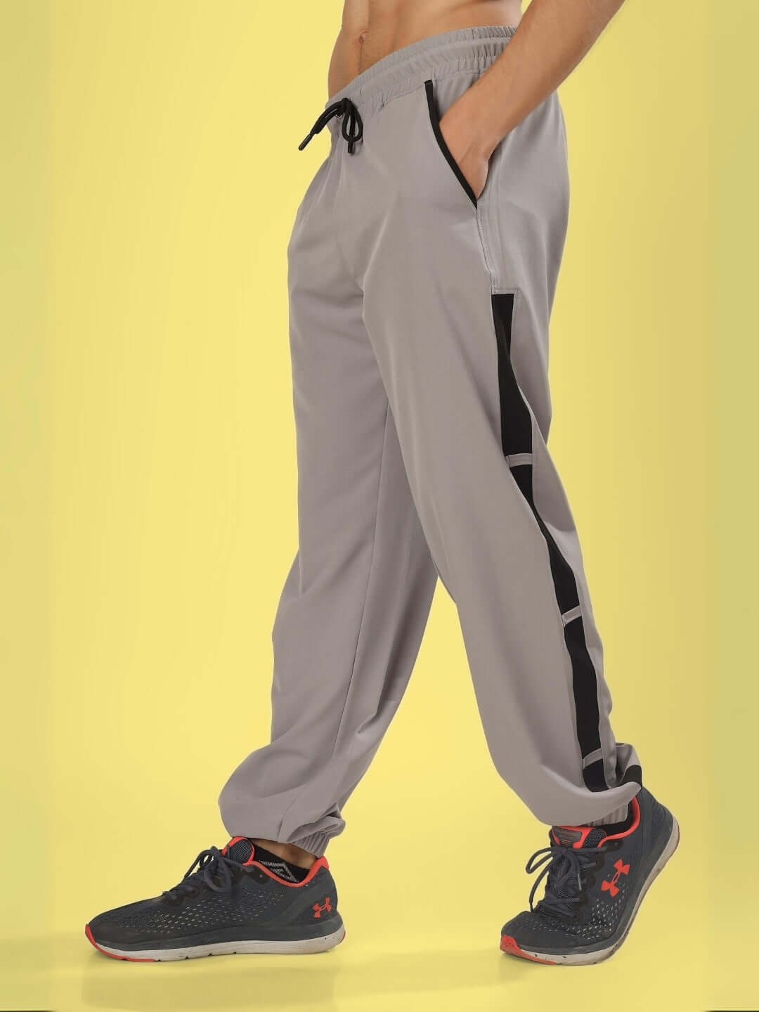 Person wearing grey BRAVO Relaxed Fit Cargo Pants showcasing side pockets and black detailing, ideal for casual wear.