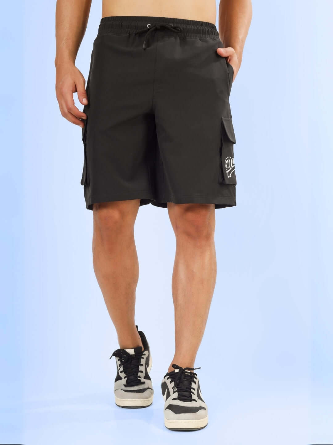 Men wearing Brawny Cargo Shorts in dark grey with custom fit option, featuring spacious pockets, shown against a light background.