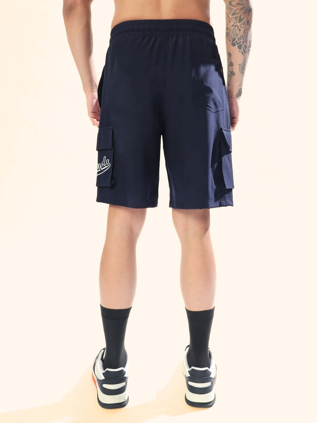 Back view of navy blue Brawny Cargo Shorts with pockets, perfect for custom fit options. Casual style for versatile wear.