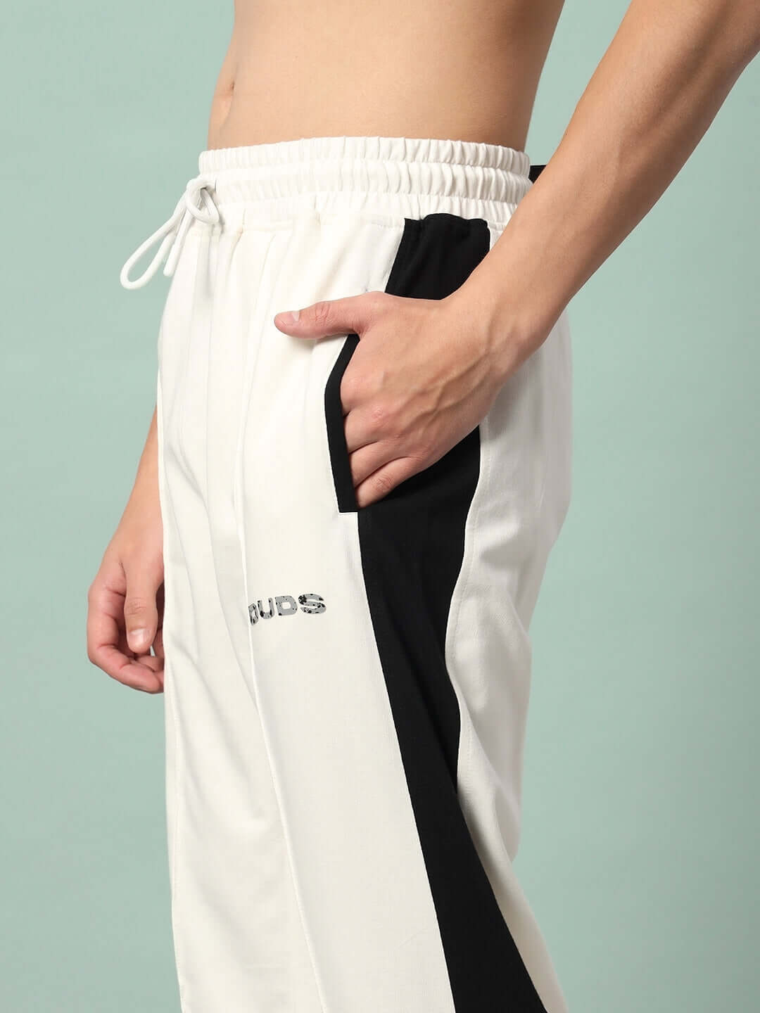 Breezer Side Contrast Joggers in off-white and black with drawstring and DUDS logo detailing, worn by a model.