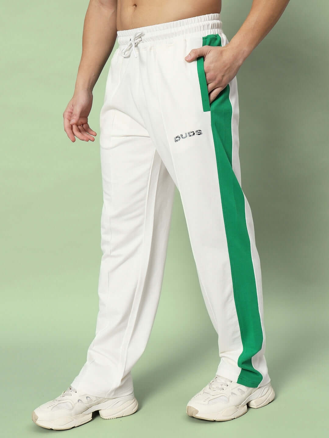 Alt Tag: Off-white joggers with green side contrast, made-to-order by DUDS, customizable fit, worn by model, featuring white sneakers.