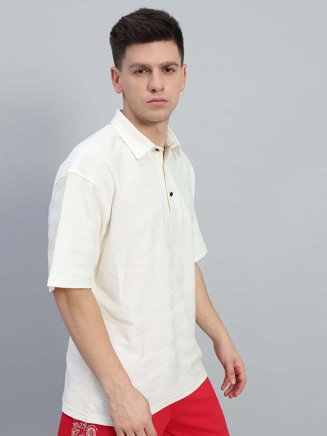Man wearing BROCADE POLO COTTON T-SHIRT OFF WHITE, showcasing textured cotton fabric with jacquard design, perfect for everyday style.