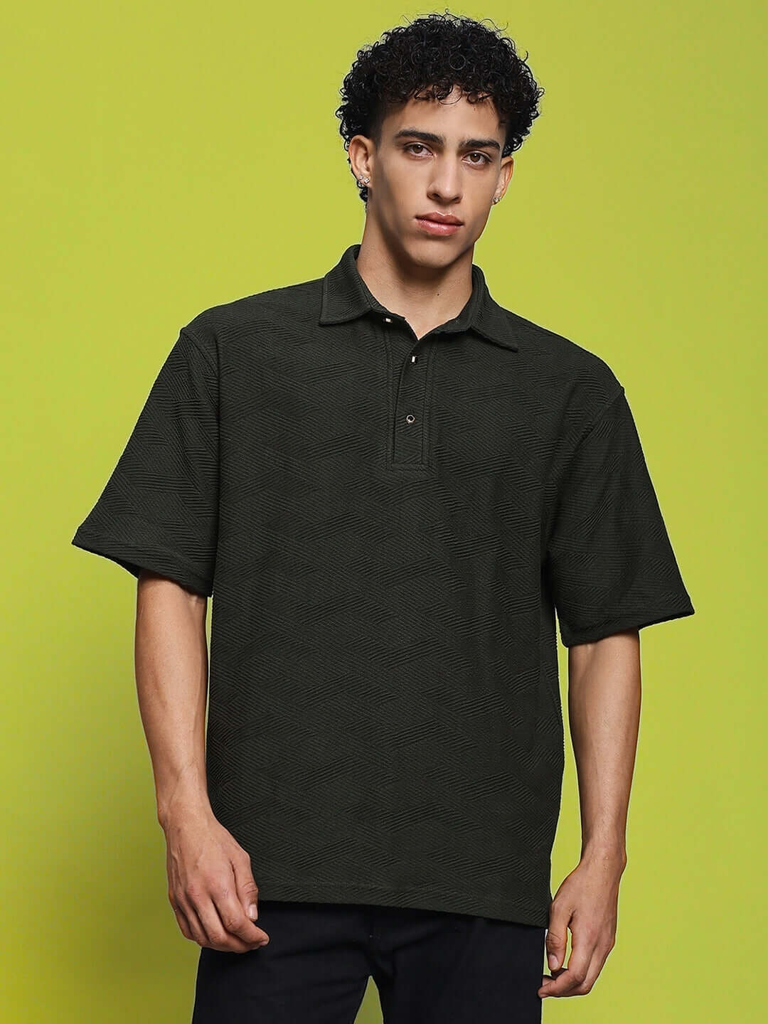 Model wearing Brocade Polo T-Shirt in dark green, half sleeves, made from premium heavy gauge cotton jacquard fabric, size large.