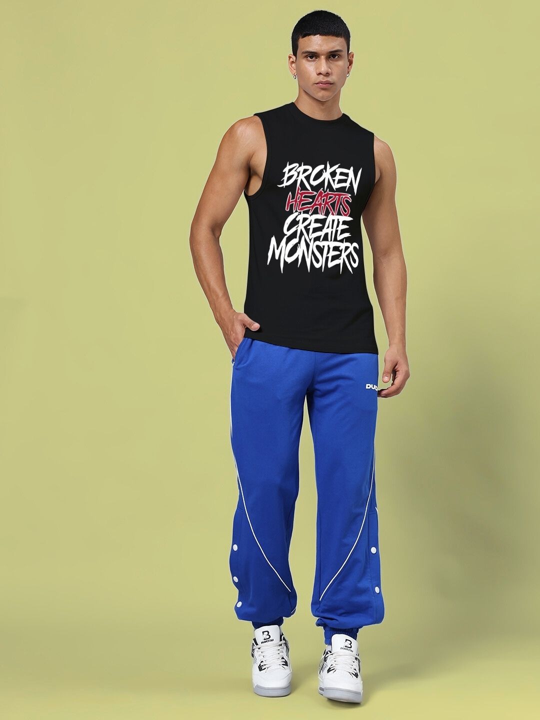 Model wearing BROKEN HEART PRINT SLEEVELESS T-SHIRT BLACK, showcasing front design.