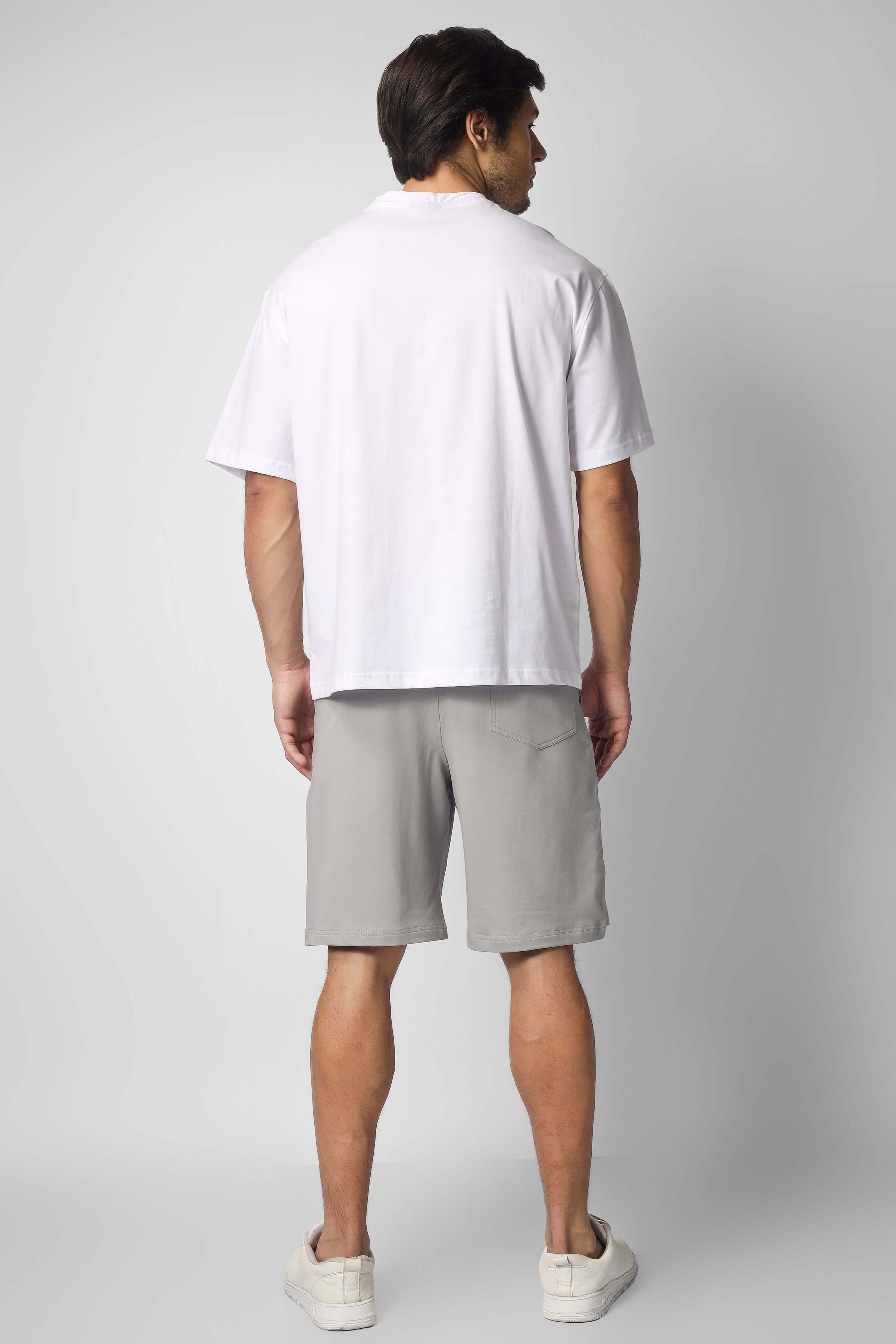 Back view of model wearing Brooklyn co-ord set in white & grey, featuring short-sleeve shirt and shorts. Perfect for customized fits.