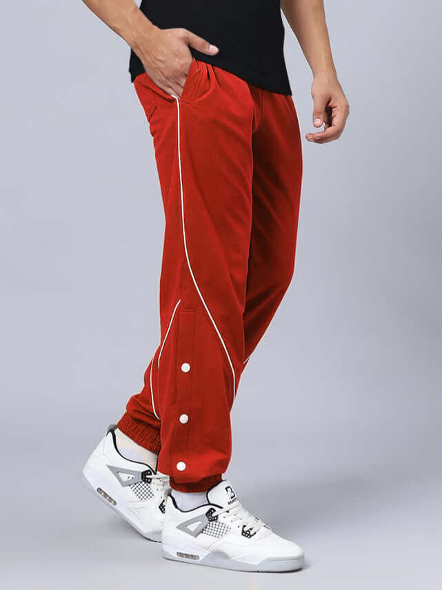 Red BROSSFINE contrast joggers with white piping, customizable fit, worn with white sneakers.